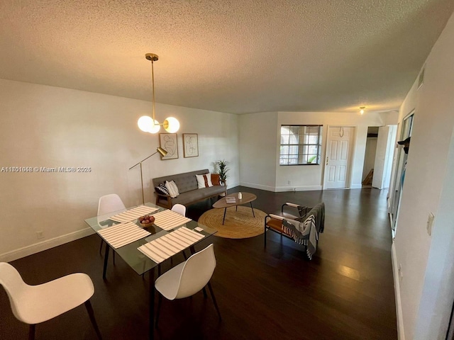 333 SW 86th Ave Unit 201, Pembroke Pines, FL 33025 - dining space featuring a textured ceiling, wood finished floors, and baseboards
