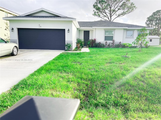 ranch-style house featuring a front lawn and a garage