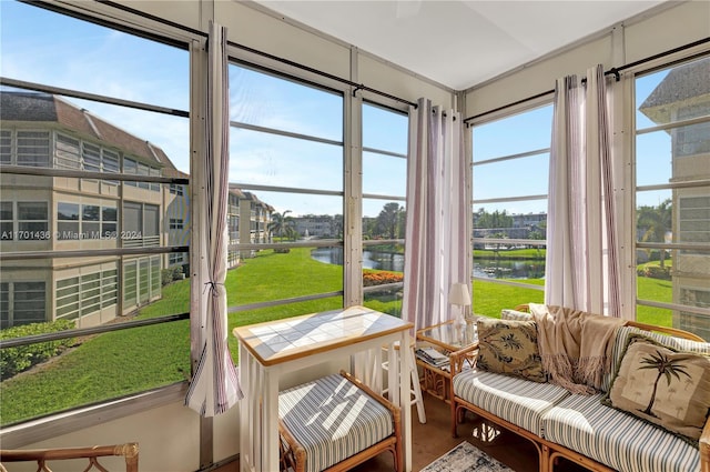 sunroom / solarium with a water view