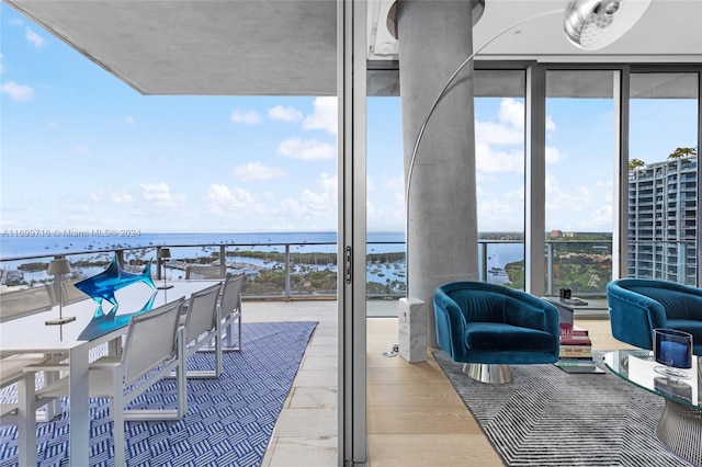 view of patio featuring an outdoor hangout area, a water view, and a balcony