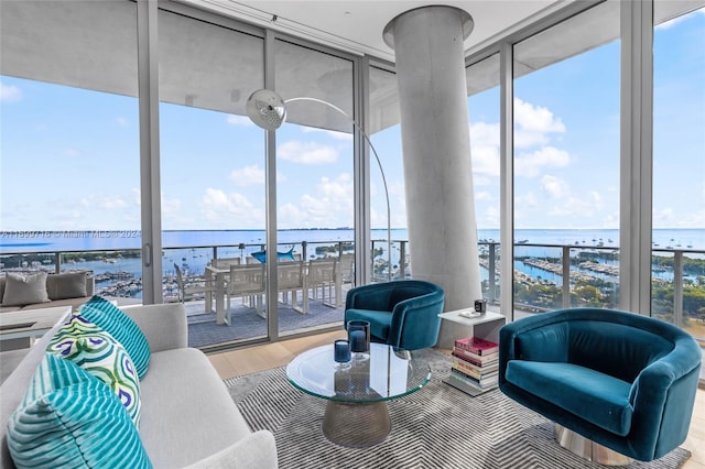 sunroom / solarium with a water view and plenty of natural light