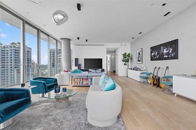 living room featuring light hardwood / wood-style floors and floor to ceiling windows