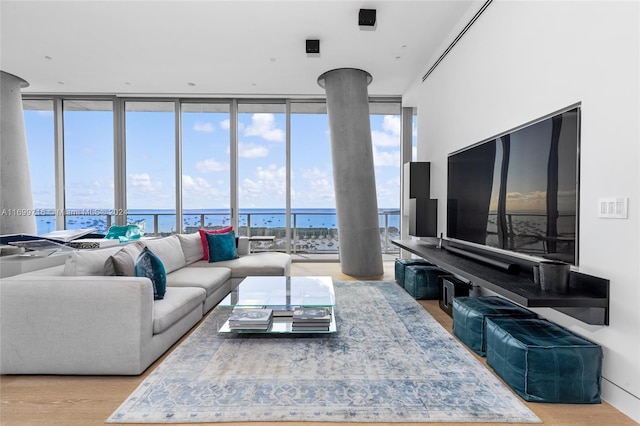 living room with floor to ceiling windows, plenty of natural light, and a water view