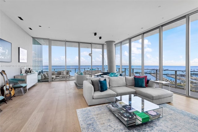 2675 S Bayshore Dr Unit 1602S, Miami, FL 33133 - living room with a wall of windows, wood finished floors, and a water view