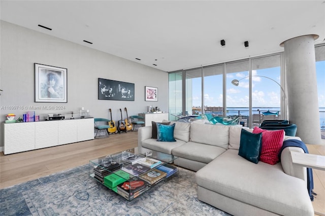 living room featuring hardwood / wood-style flooring and a wall of windows