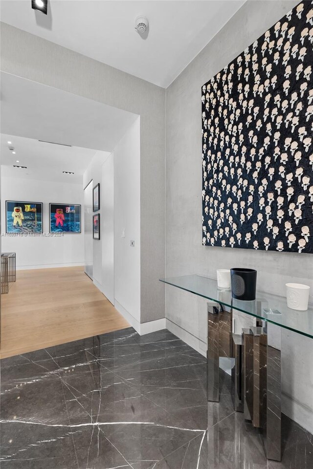 2675 S Bayshore Dr Unit 1602S, Miami, FL 33133 - corridor featuring baseboards and dark marble finish floors