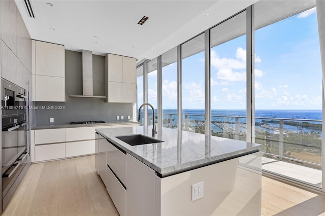 2675 S Bayshore Dr Unit 1602S, Miami, FL 33133 - kitchen featuring modern cabinets, a sink, wall chimney range hood, and a water view