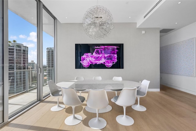 dining area with expansive windows, a healthy amount of sunlight, and light wood-type flooring