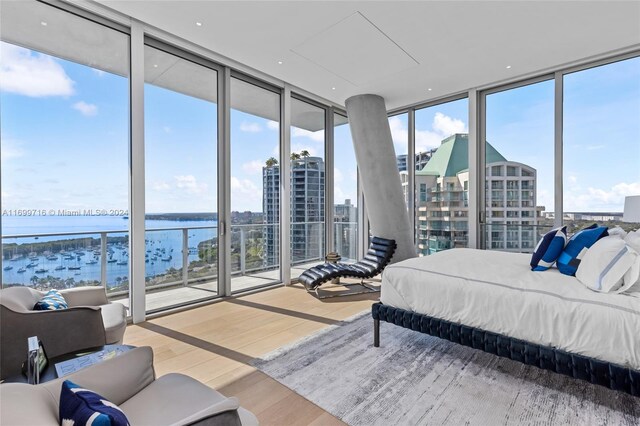 2675 S Bayshore Dr Unit 1602S, Miami, FL 33133 - bedroom featuring a wall of windows, a water view, wood finished floors, and access to outside