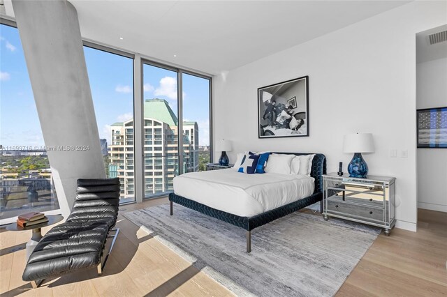2675 S Bayshore Dr Unit 1602S, Miami, FL 33133 - bedroom featuring a wall of windows, wood finished floors, and access to outside