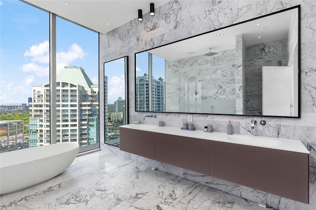 bathroom with separate shower and tub, vanity, and tile walls