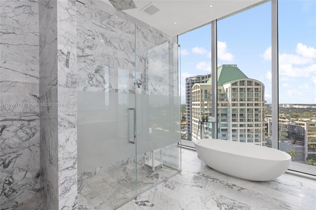 2675 S Bayshore Dr Unit 1602S, Miami, FL 33133 - bathroom featuring a marble finish shower, marble tiled flooring, expansive windows, a freestanding bath, and a view of city