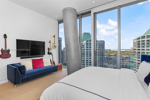 2675 S Bayshore Dr Unit 1602S, Miami, FL 33133 - bedroom featuring wood finished floors, a wall of windows, and a city view