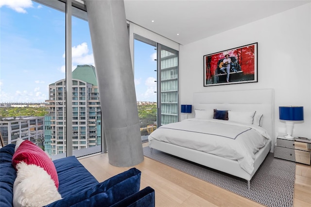 bedroom featuring hardwood / wood-style floors and floor to ceiling windows