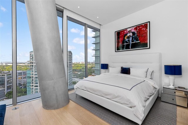 2675 S Bayshore Dr Unit 1602S, Miami, FL 33133 - bedroom with a wall of windows, a city view, and wood finished floors