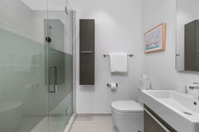 bathroom featuring vanity, an enclosed shower, and toilet