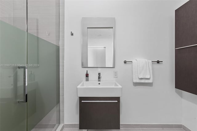 bathroom featuring vanity, tile patterned floors, and an enclosed shower