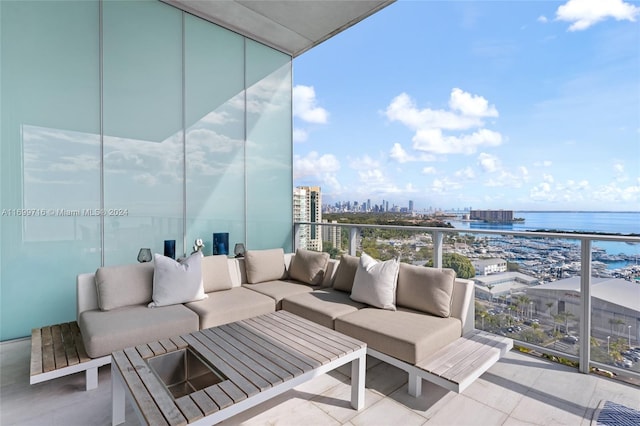 balcony featuring a water view and an outdoor hangout area