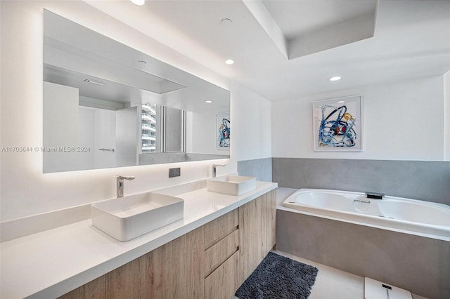 bathroom with a bath and vanity