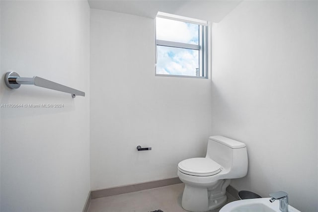 bathroom featuring a bidet and toilet