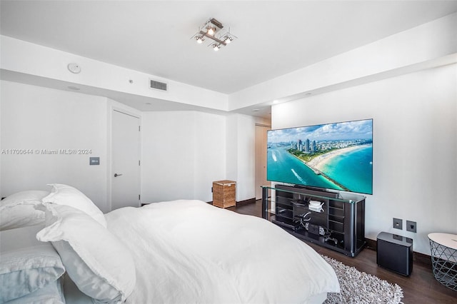 bedroom with dark wood-type flooring