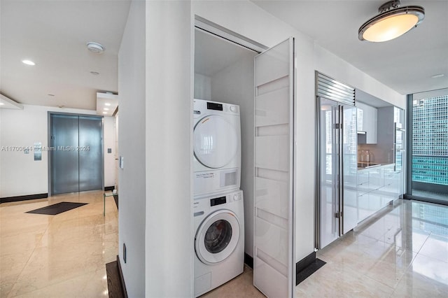 laundry area featuring stacked washer and clothes dryer