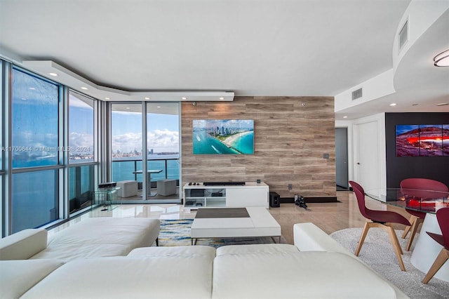 living room with wood walls and a wall of windows