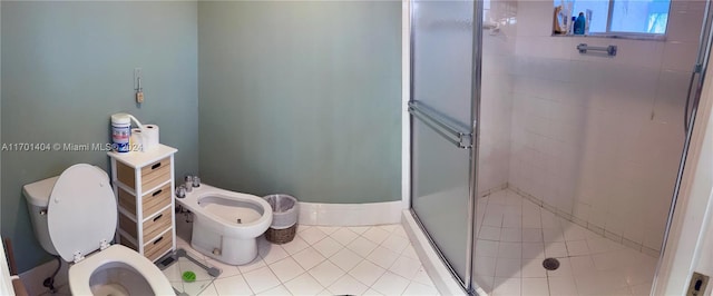 bathroom with tile patterned flooring, toilet, walk in shower, and a bidet