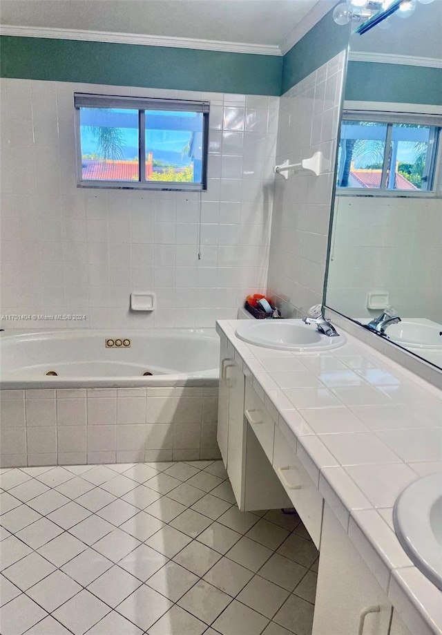 bathroom featuring tile patterned floors, vanity, a relaxing tiled tub, and ornamental molding