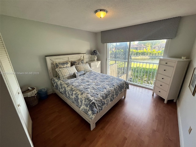 10244 NW 51st Ter, Doral, FL 33178 - bedroom featuring dark wood-type flooring, access to outside, and a textured ceiling