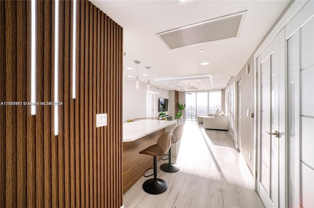 hallway with light hardwood / wood-style floors