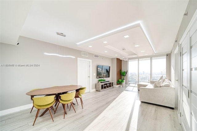 living room featuring light hardwood / wood-style floors and a wall of windows