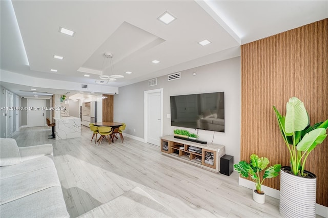 living room featuring wood walls and light wood-type flooring