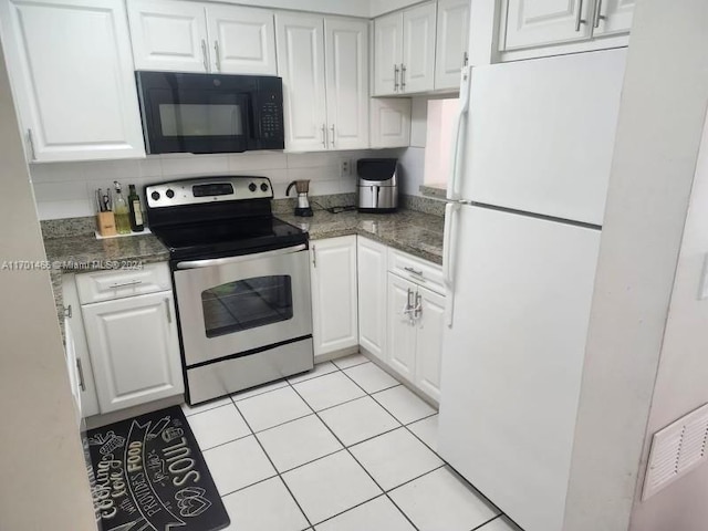 kitchen with decorative backsplash, electric range, white fridge, and white cabinetry