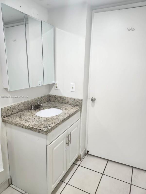 bathroom with tile patterned flooring and vanity