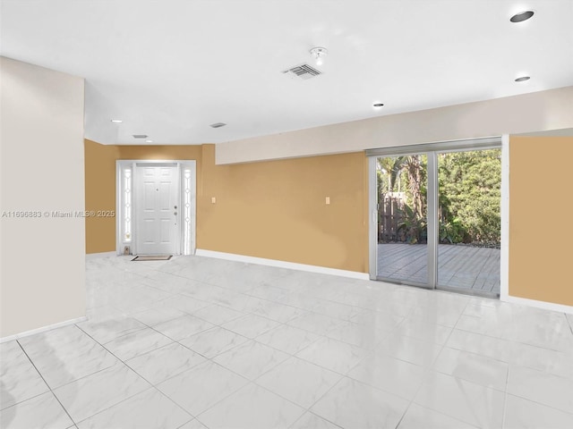 spare room featuring visible vents and baseboards