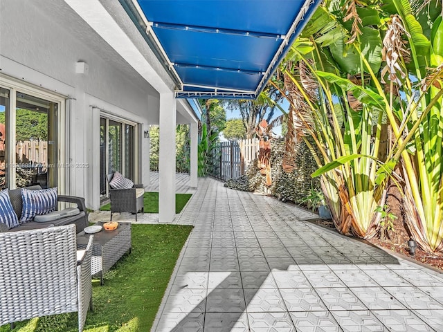 view of patio / terrace featuring fence and an outdoor living space