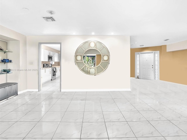 spare room featuring light tile patterned flooring, recessed lighting, visible vents, and baseboards