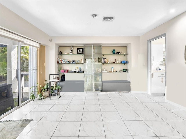 interior space with baseboards and visible vents