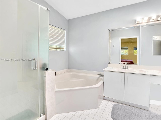 bathroom featuring a garden tub, a shower stall, tile patterned flooring, and vanity