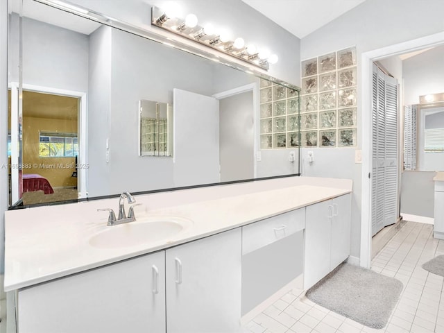 bathroom with ensuite bathroom, tile patterned flooring, and vanity