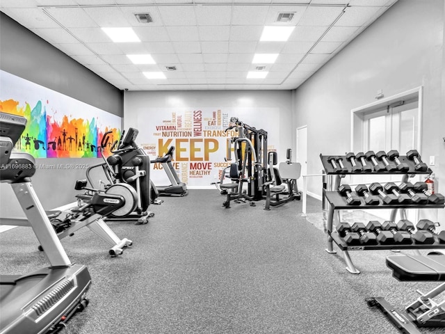 workout area featuring visible vents and a paneled ceiling