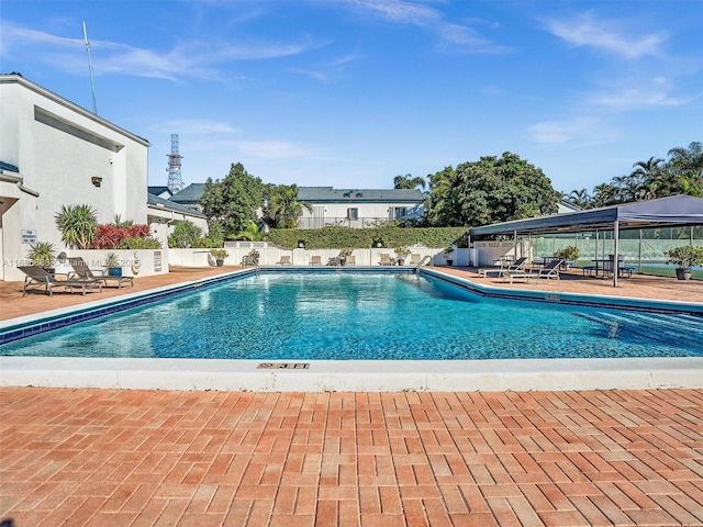 community pool featuring a patio area and fence