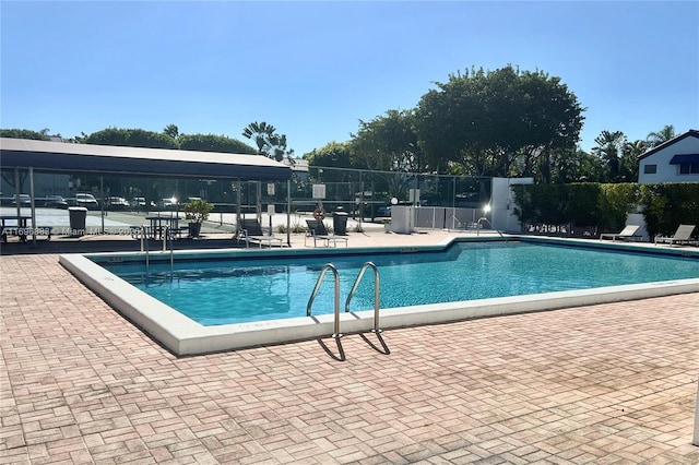 pool featuring a patio area and fence