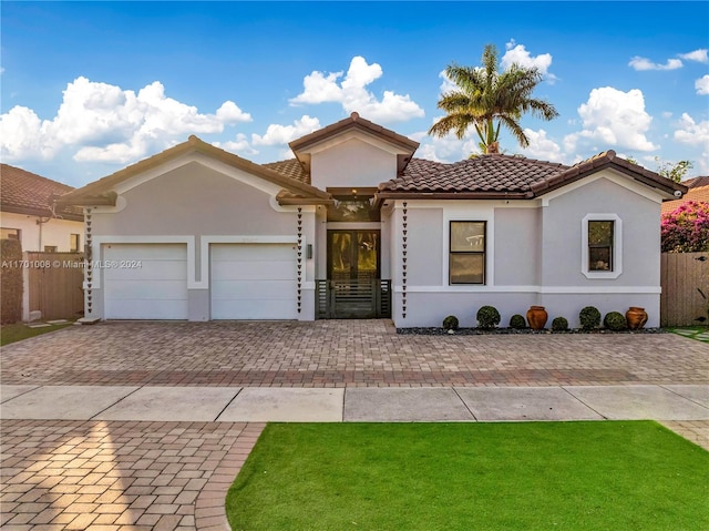 mediterranean / spanish home featuring a garage