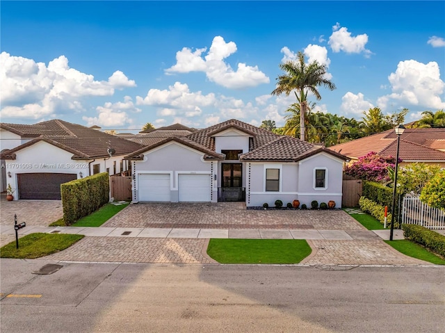 mediterranean / spanish-style home with a garage