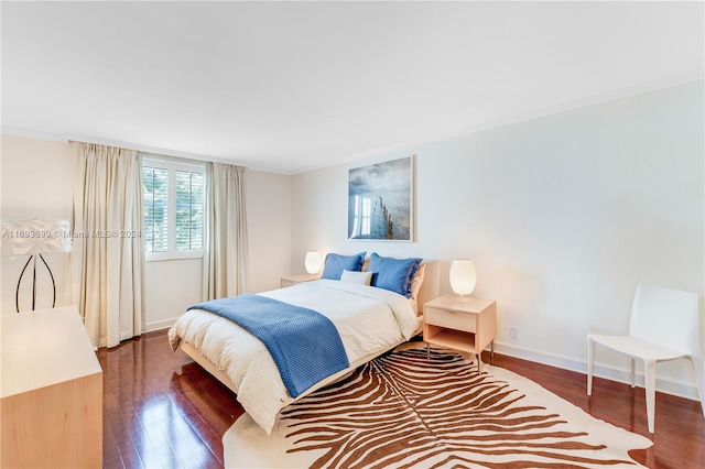 bedroom featuring dark hardwood / wood-style flooring and crown molding