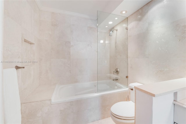 bathroom featuring tiled shower / bath combo, toilet, crown molding, and tile walls