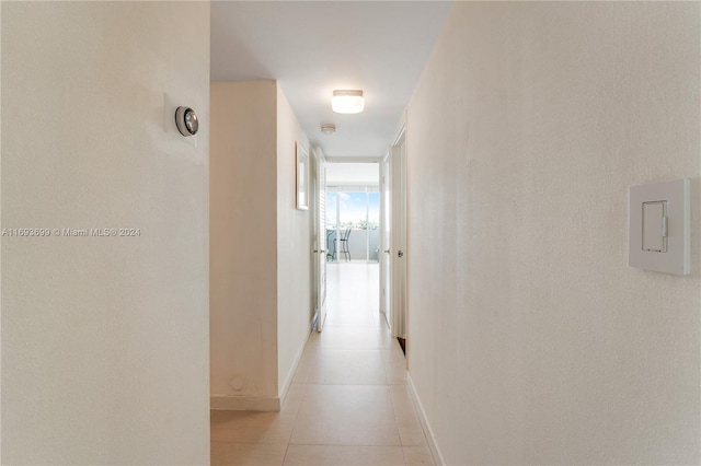 corridor with light tile patterned floors