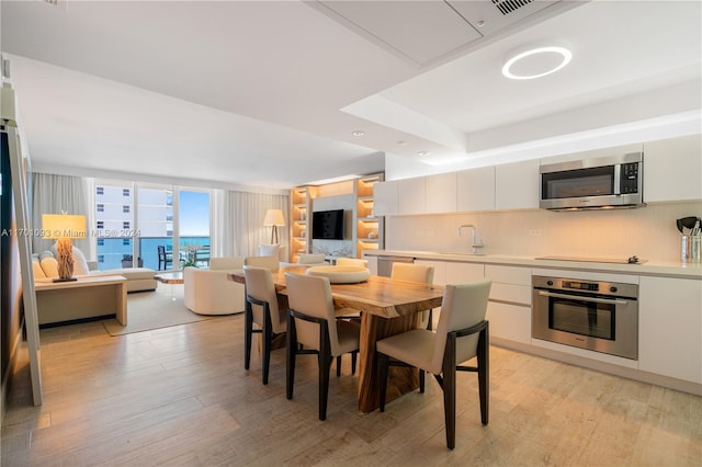 dining area featuring light hardwood / wood-style flooring and sink